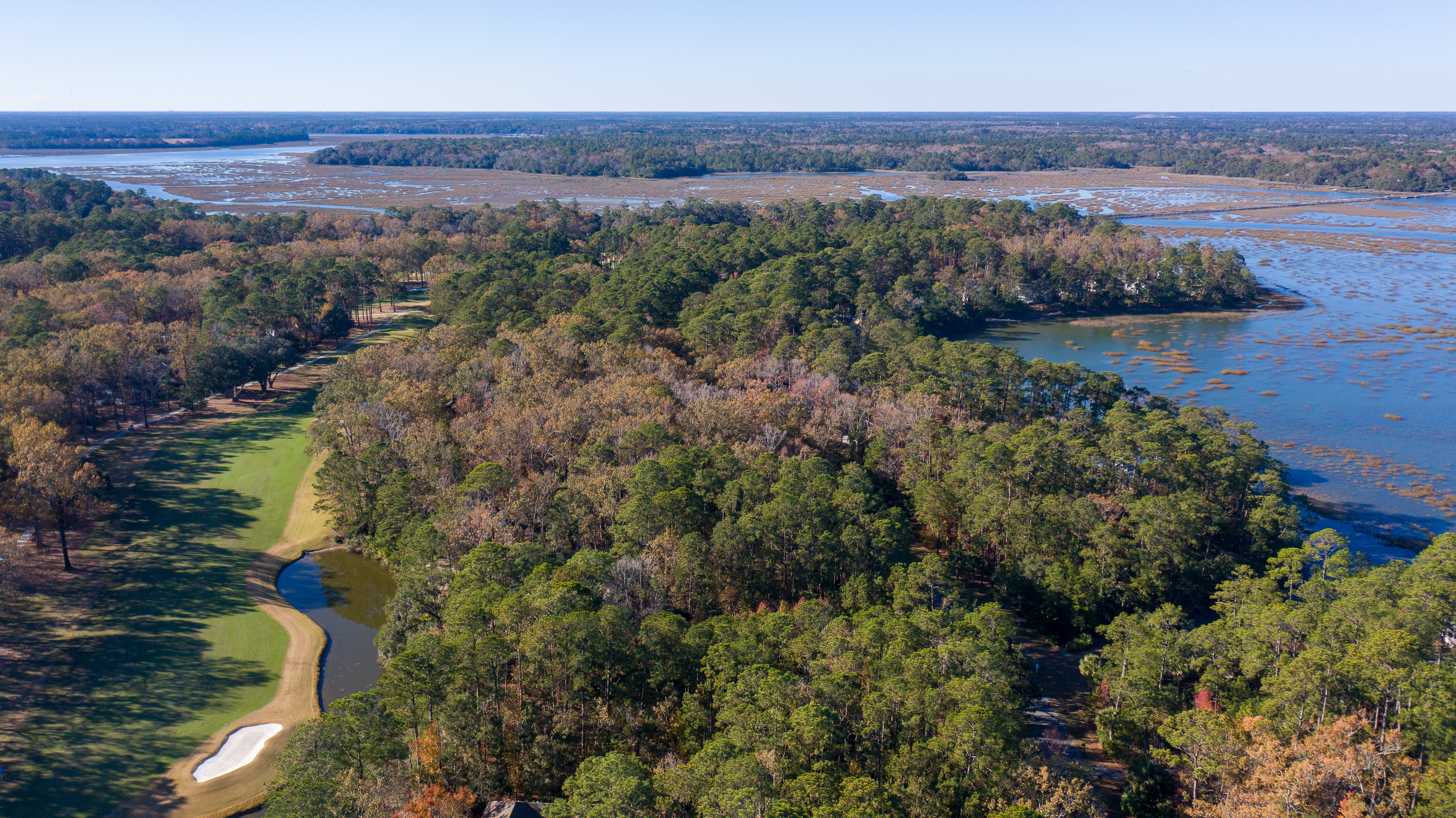 Front view of 4 Spartina Point Drive in Moss Creek, a Kermitt Huggins–designed home with contemporary stucco exterior and marsh backdrop – listed by Allison Cobb of The Cobb Group eXp Luxury Realty.